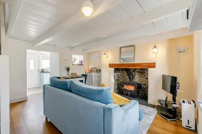 a living room with a blue couch and a fireplace at 1 Bed in Marazion oc-lynwo in Marazion