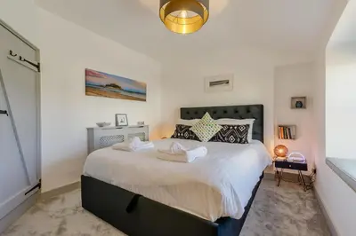 a bedroom with a large bed with white sheets at 1 Bed in Marazion oc-lynwo in Marazion