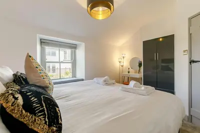 a bedroom with a large white bed with pillows at 1 Bed in Marazion oc-lynwo in Marazion