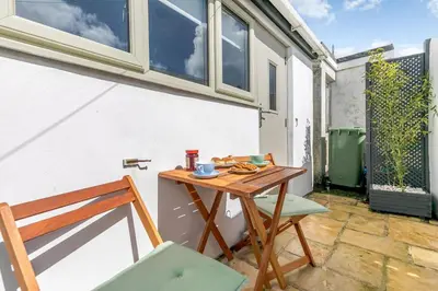 a small table and two chairs on a patio at 1 Bed in Marazion oc-lynwo in Marazion