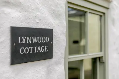 a sign on a building that reads hyyn wood conference at 1 Bed in Marazion oc-lynwo in Marazion