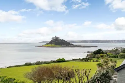 a view of a castle on an island in the water at 1 Bed in Marazion oc-lynwo in Marazion