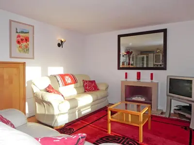 a living room with a white couch and a fireplace at 3 Bed in Porthleven oc-lamorn in Porthleven