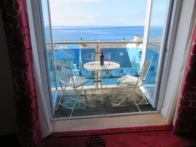 a room with a view of the ocean from a balcony at 3 Bed in Porthleven oc-lamorn in Porthleven