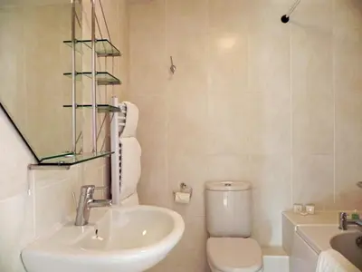 a white bathroom with a sink and a toilet at 3 Bed in Porthleven oc-lamorn in Porthleven