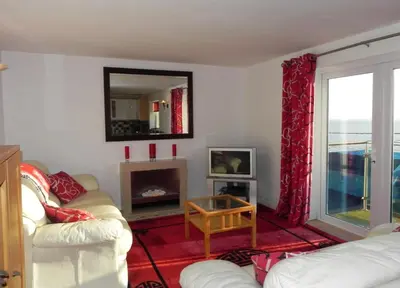 a living room with two white couches and a fireplace at 3 Bed in Porthleven oc-lamorn in Porthleven