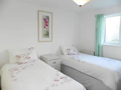 a bedroom with two beds and a window at 3 Bed in Porthleven oc-lamorn in Porthleven