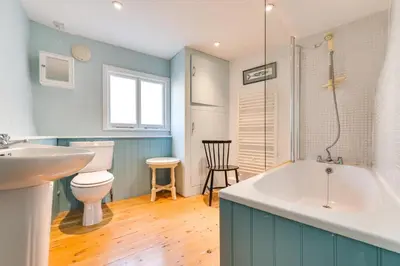 a bathroom with a tub and a toilet and a sink at 3 Bed in Fowey oc-litin in Fowey