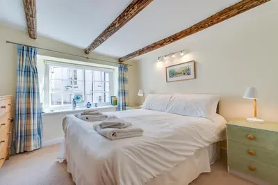 a bedroom with a bed with towels on it at 3 Bed in Fowey oc-litin in Fowey