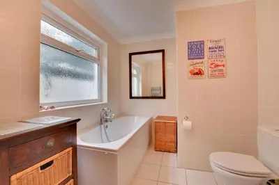 a bathroom with a tub and a toilet and a sink at 2 Bed in Porthleven oc-lampho in Porthleven