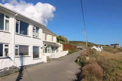 an empty street next to a white house at 2 Bed in Porthleven oc-lampho in Porthleven