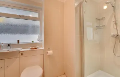 a bathroom with a shower and a toilet and a sink at 2 Bed in Porthleven oc-lampho in Porthleven