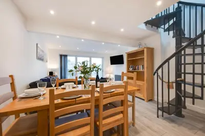 a dining room with a wooden table and chairs at 3 Bed in Looe oc-l30071 in Looe
