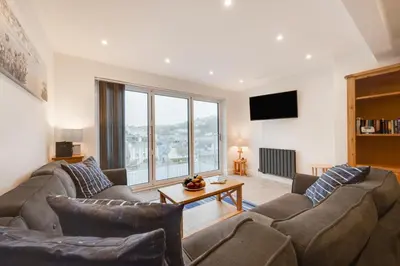 a living room with a couch and a table at 3 Bed in Looe oc-l30071 in Looe