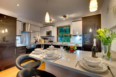 a kitchen with a table with dishes on it at 2 Bed in Looe oc-l30065 in Looe