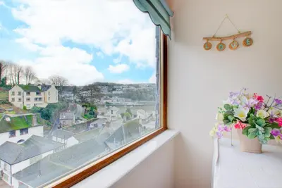 a window with a vase of flowers on a window sill at 3 Bed in Looe oc-l30064 in Looe