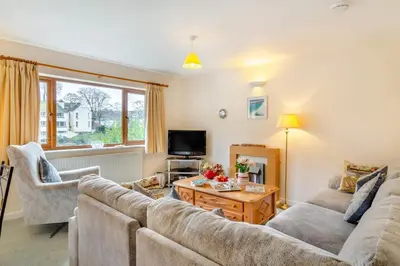 a living room with a couch and a table at 3 Bed in Looe oc-l30064 in Looe