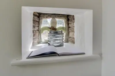 a book and a vase on a shelf with a window at 1 Bed in Duloe oc-l30057 in Duloe