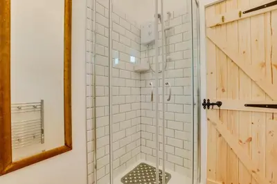 a shower in a bathroom with a mirror at 1 Bed in Duloe oc-l30057 in Duloe