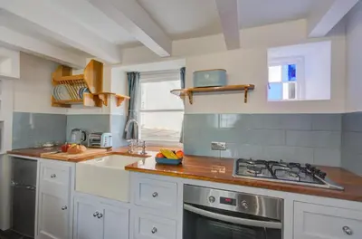a kitchen with white cabinets and a stove top oven at 2 Bed in West Looe oc-l30054 in Looe