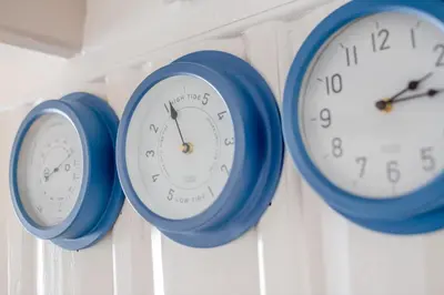four clocks are hanging on a wall at 3 Bed in Looe oc-l30053 in Looe