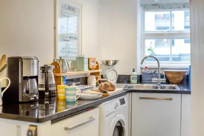 a kitchen counter with a sink and a dishwasher at 3 Bed in Looe oc-l30053 in Looe