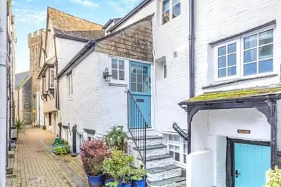 a white house with blue doors on a street at 3 Bed in Looe oc-l30053 in Looe