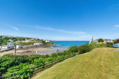 a view of the beach and ocean from a hill at 3 Bed in Mevagissey oc-windru in Mevagissey