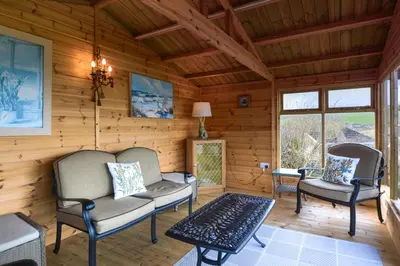 a living room with two chairs and a couch at 3 Bed in Mevagissey oc-windru in Mevagissey
