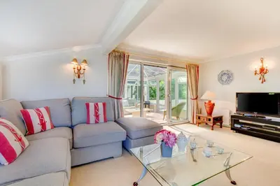 a living room with a blue couch and a tv at 3 Bed in Mevagissey oc-windru in Mevagissey