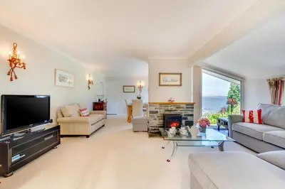 a living room with a television and a fireplace at 3 Bed in Mevagissey oc-windru in Mevagissey