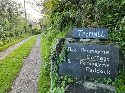 a sign on the side of a dirt road at 2 Penmayne Cottage in Saint Minver