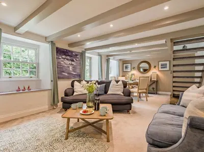 a large living room with couches and a table at 2 Penmayne Cottage in Saint Minver