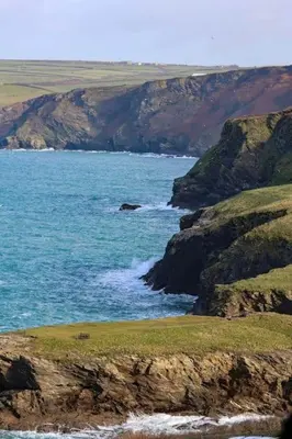 a view of a body of water with a mountain at Number 9, Port Isaac Bay Holidays in Port Isaac