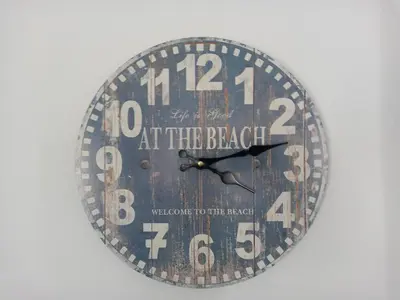 a clock that is hanging on a wall at Ruby's Den in Carbis Bay