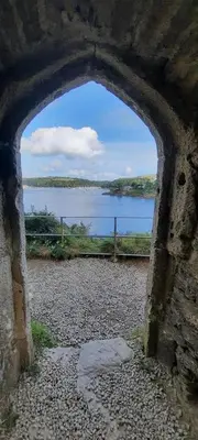 an archway in a building with a view of a body of water at The Captain’s 4 Bed Penthouse in Fowey