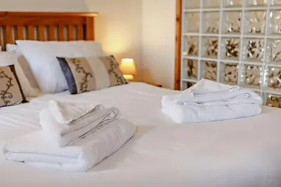 a bedroom with two white towels on a bed at 1 Bed in Garras oc-l27431 in Mawgan