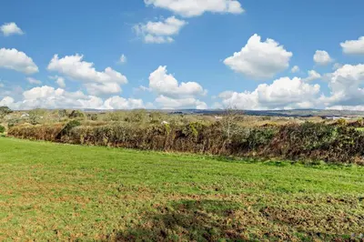a field with green grass and clouds in the sky at 1 Bed in Garras oc-l27431 in Mawgan