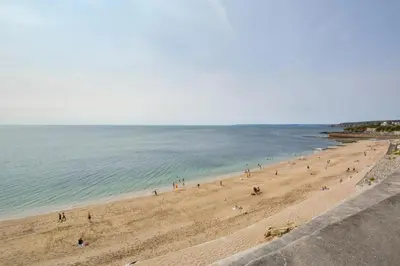 a group of people on a beach near the water at 2 Bed in Porthleven oc-marin2 in Porthleven