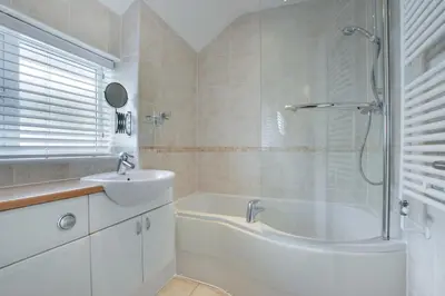 a bathroom with a tub and a sink and a shower at 2 Bed in Porthleven oc-marin2 in Porthleven