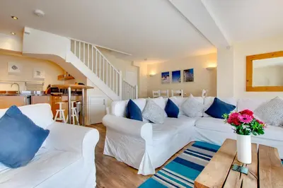 a living room with white couches and blue pillows at 2 Bed in Porthleven oc-marin2 in Porthleven