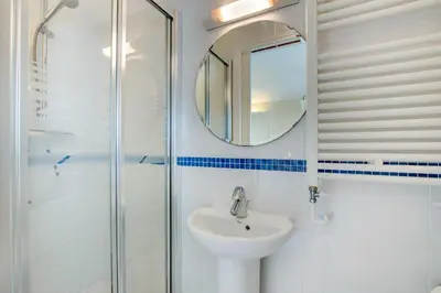 a white bathroom with a sink and a mirror at 2 Bed in Porthleven oc-marin2 in Porthleven