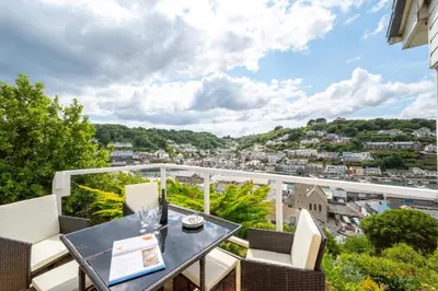 a balcony with a table and chairs and a view at 2 Bed in Looe oc-mizzen in Looe