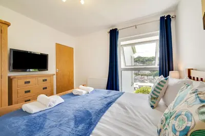a bedroom with a bed with towels on it at 2 Bed in Looe oc-mizzen in Looe