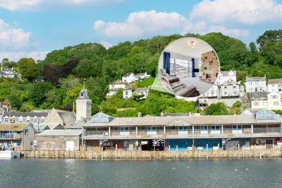 a large building on the shore of a body of water at 2 Bed in Looe oc-mizzen in Looe