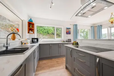 a kitchen with gray cabinets and a sink at 2 Bed in Looe oc-mizzen in Looe