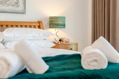 a bedroom with a bed with white sheets and pillows at 3 Bed in Newquay oc-mordh in Newquay