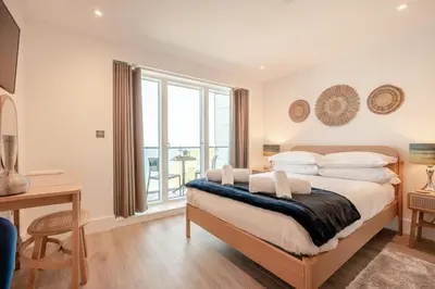 a bedroom with a bed and a desk and a window at 3 Bed in Newquay oc-mordh in Newquay