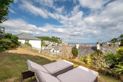 a balcony with a couch and a view of the city at 2 Bed in Looe oc-msweet in Looe