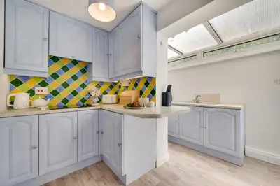 a kitchen with white cabinets and a counter top at 2 Bed in Looe oc-msweet in Looe